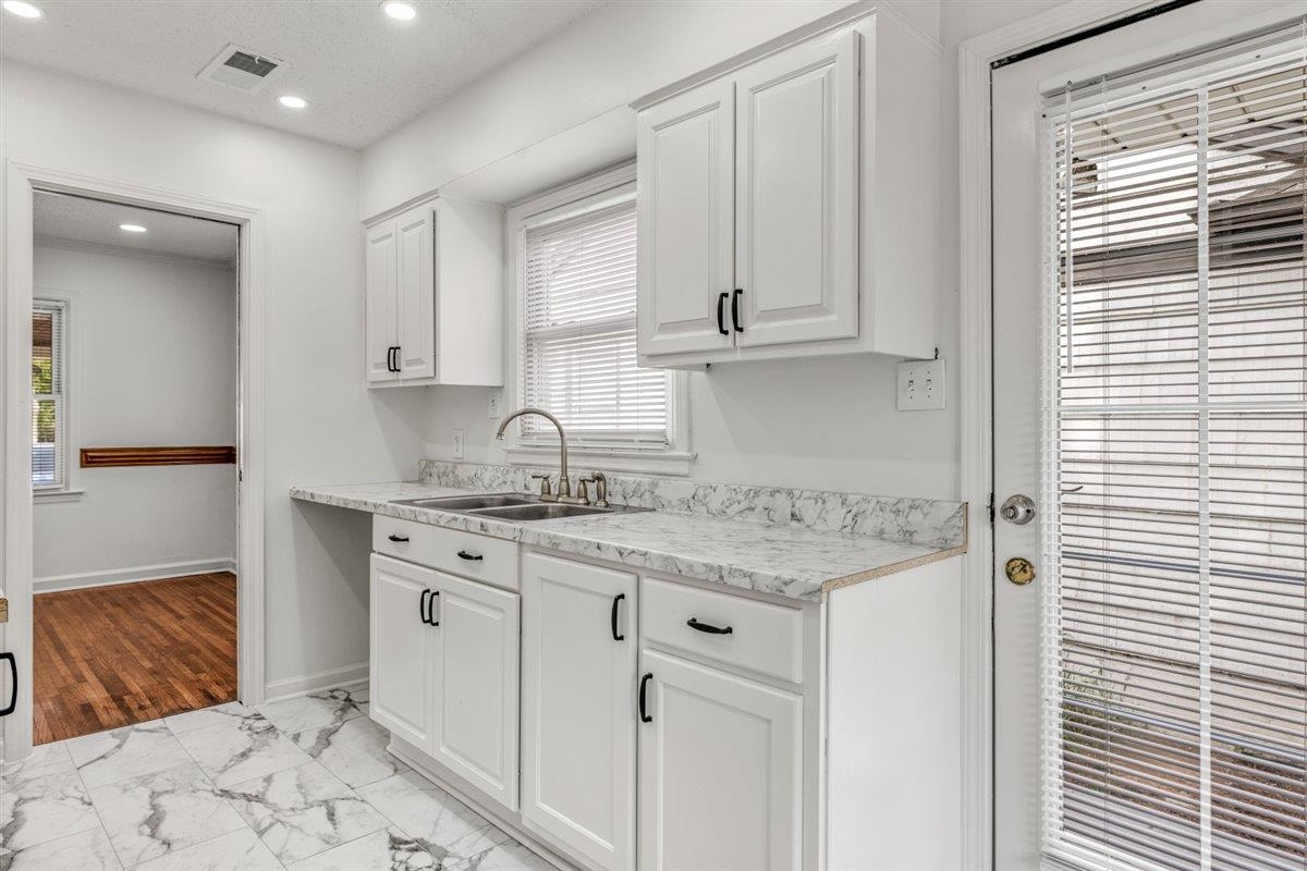 1244 Wells Station Road Memphis, TN 38122 - Photo 15 of 36 Kitchen featuring white cabinetry, light countertops, recessed lighting, and light marble finish floors