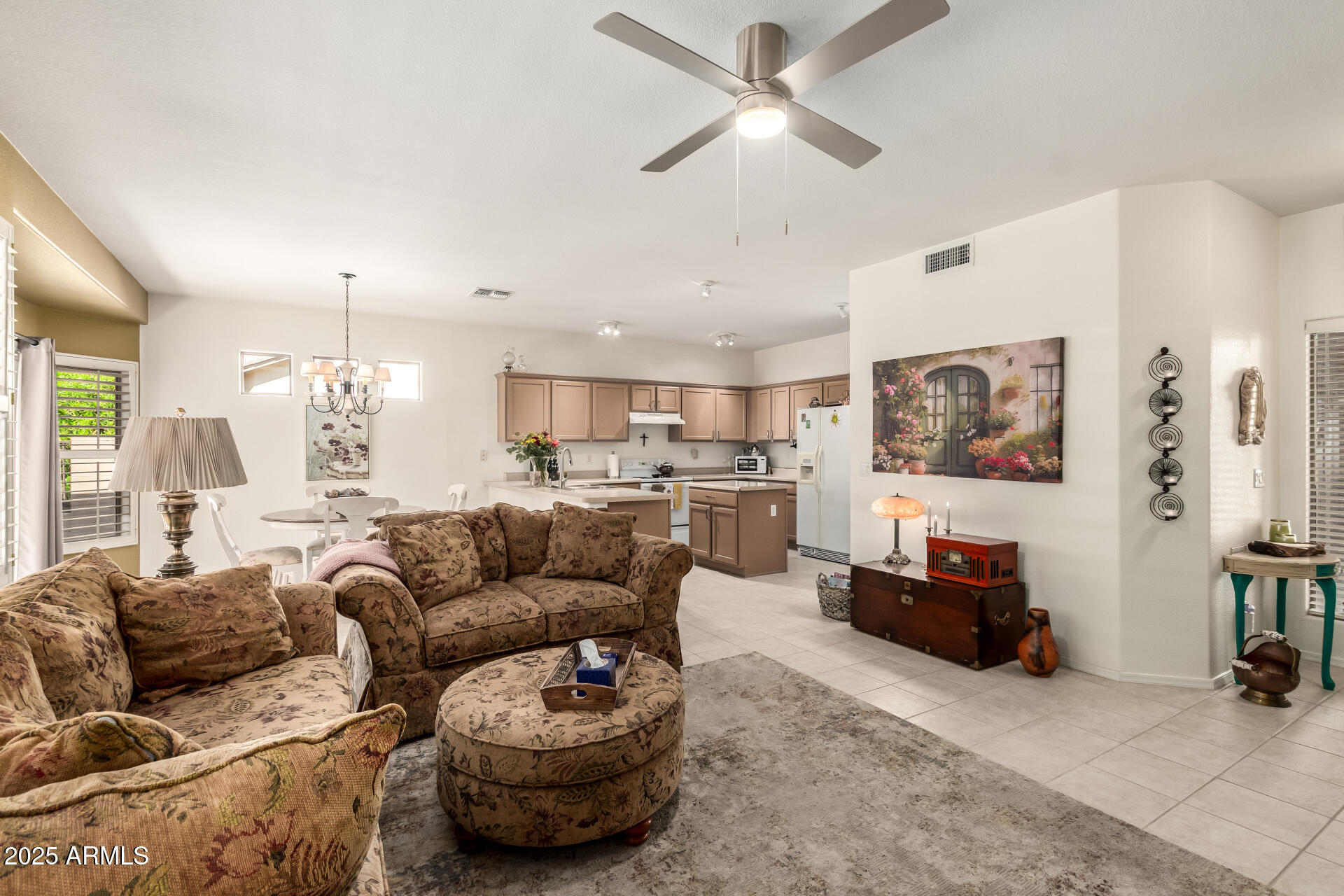 6972 South Nantucket Street Chandler, AZ 85249 - Photo 6 of 40 a living room with furniture kitchen view and a chandelier