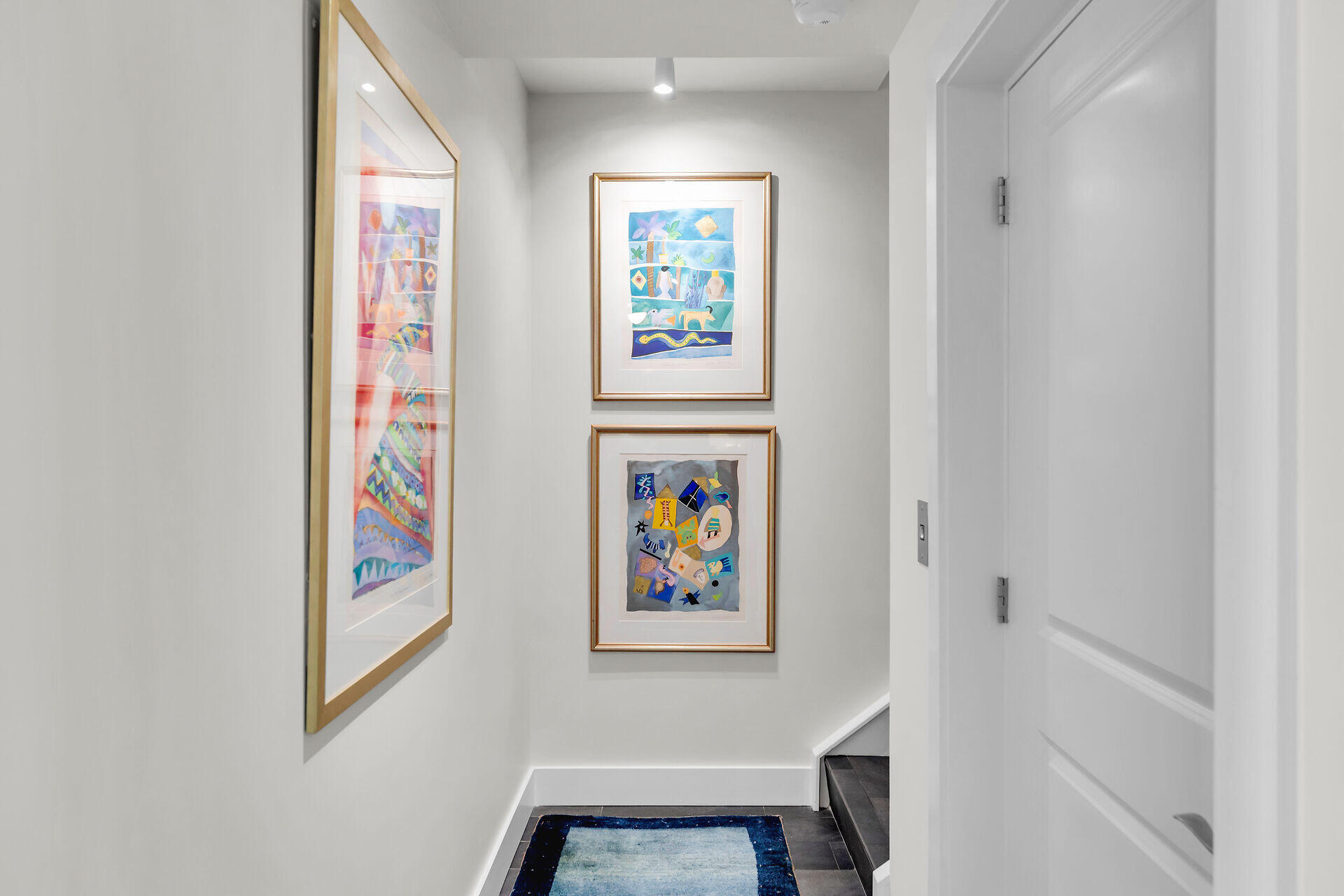 141 Simonton Street Key West, FL 33040 - Photo 18 of 49 a view of a hallway with paintings on the wall