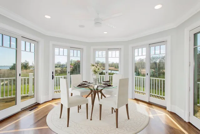 a view of a livingroom with furniture and floor to ceiling window