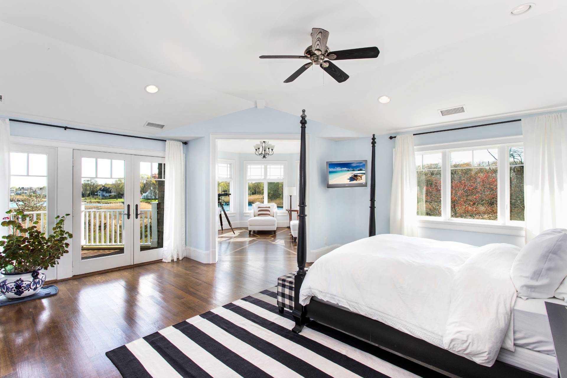 Undisclosed Address Westhampton Beach, NY 11978 - Photo 15 of 16 a bedroom with a large bed and wooden floor