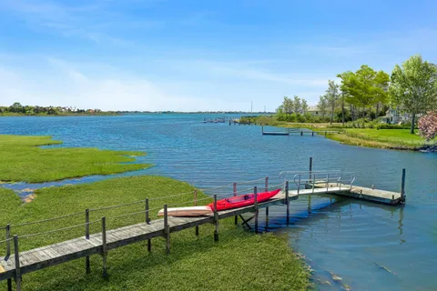 a view of a lake with a table and chairs