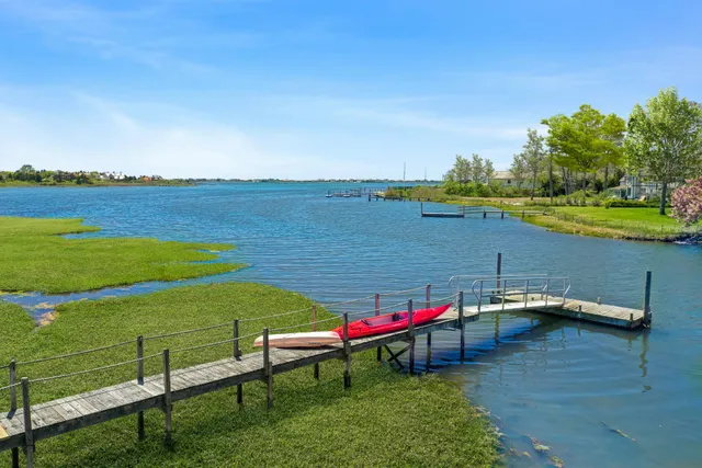 a view of a lake with a table and chairs