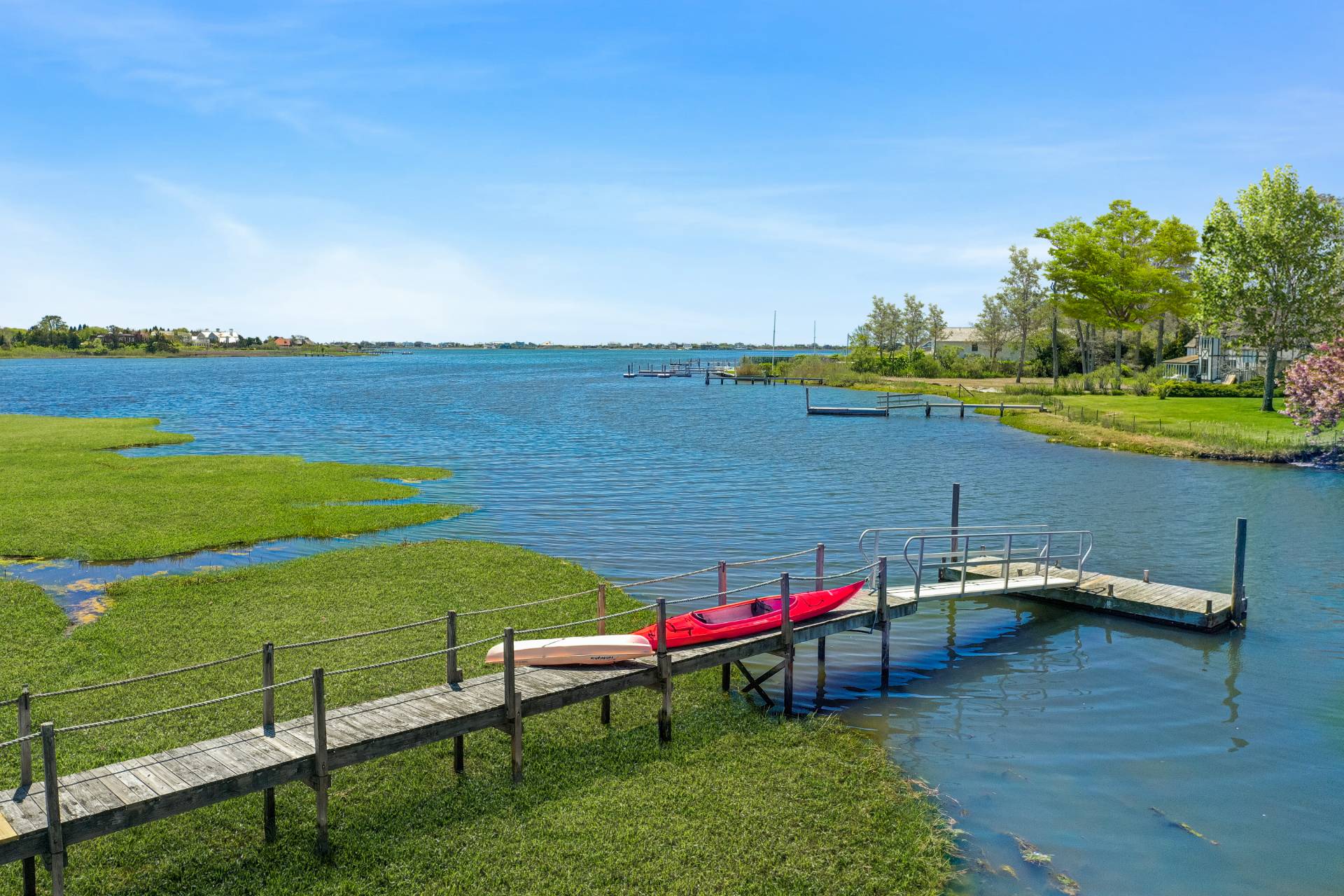 Undisclosed Address Westhampton Beach, NY 11978 - Photo 3 of 16 a view of a lake with a table and chairs