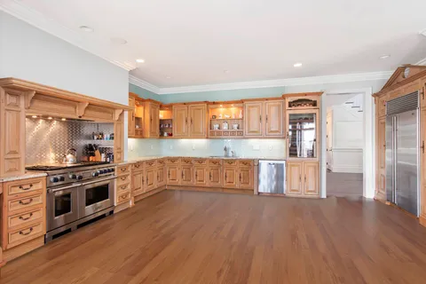 a kitchen with stainless steel appliances a stove top oven and a refrigerator
