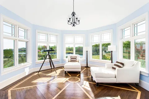a living room with fireplace furniture and a large window