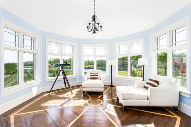 a living room with fireplace furniture and a large window