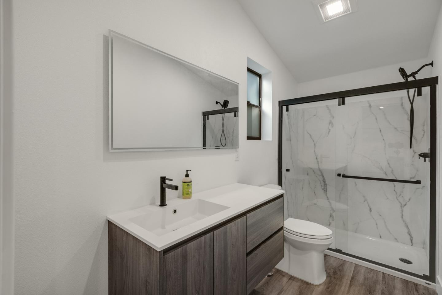 13398 Pierce Road Saratoga, CA 95070 - Photo 14 of 19 a bathroom with a sink toilet and shower