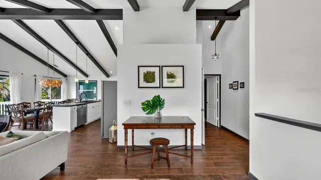 a living room with furniture and a floor to ceiling window
