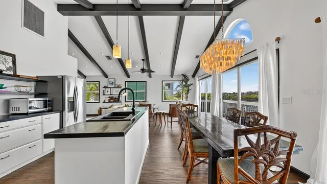a kitchen with stainless steel appliances a sink stove and refrigerator