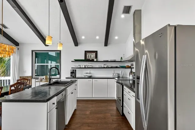 a bedroom with a bed and a large mirror on the dresser