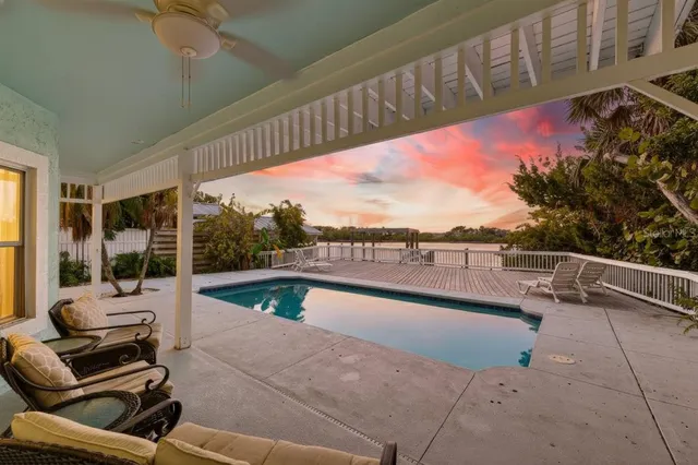 a view of roof deck with wooden floor and fence