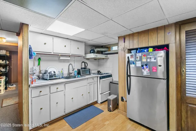 a kitchen with stainless steel appliances a refrigerator sink and cabinets
