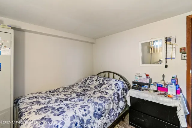 a bedroom with a bed and a dresser in it