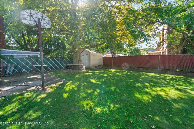 a backyard of a house with lots of green space and garden
