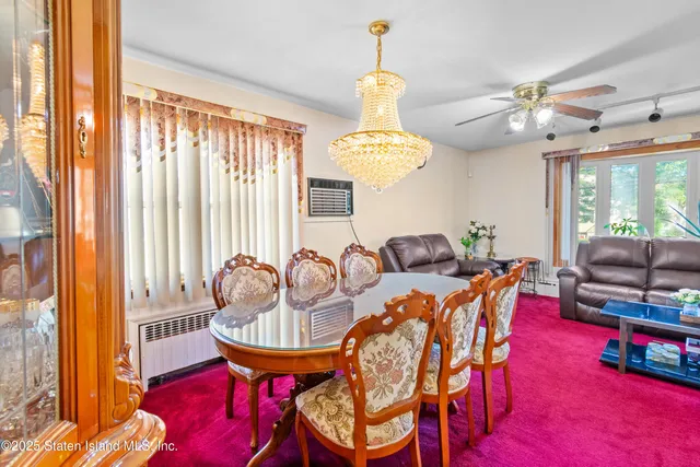 a view of a dining room with furniture and a chandelier