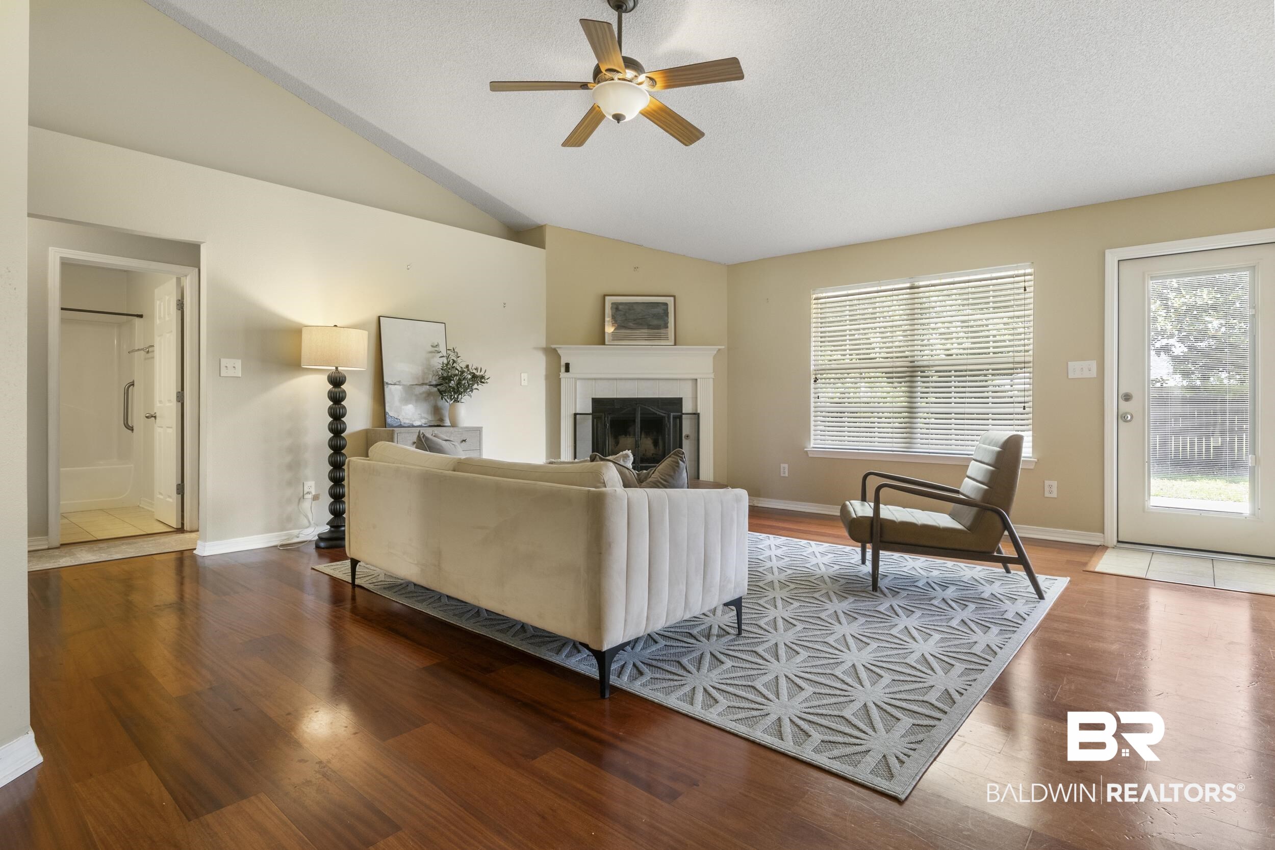 9610 Watkins Drive Fairhope, AL 36532 - Photo 23 of 26 Living room featuring ceiling fan, lofted ceiling, and hardwood / wood-style floors