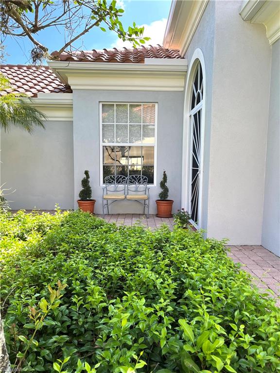 5477 Freeport Lane Naples, FL 34119 - Photo 3 of 36 a backyard of a house with outdoor seating and plants
