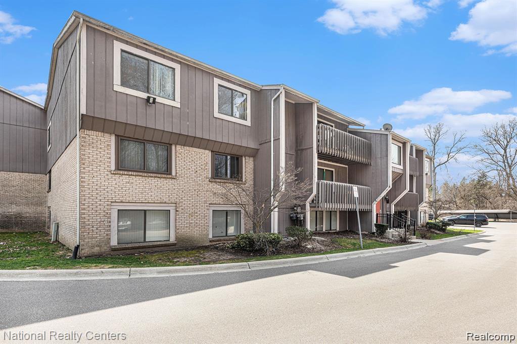 29870 West 12 Mile Road, Unit 703 Farmington, MI 48334 - Photo 40 of 40 Multi-story residential building featuring a brick base and upper levels with horizontal siding