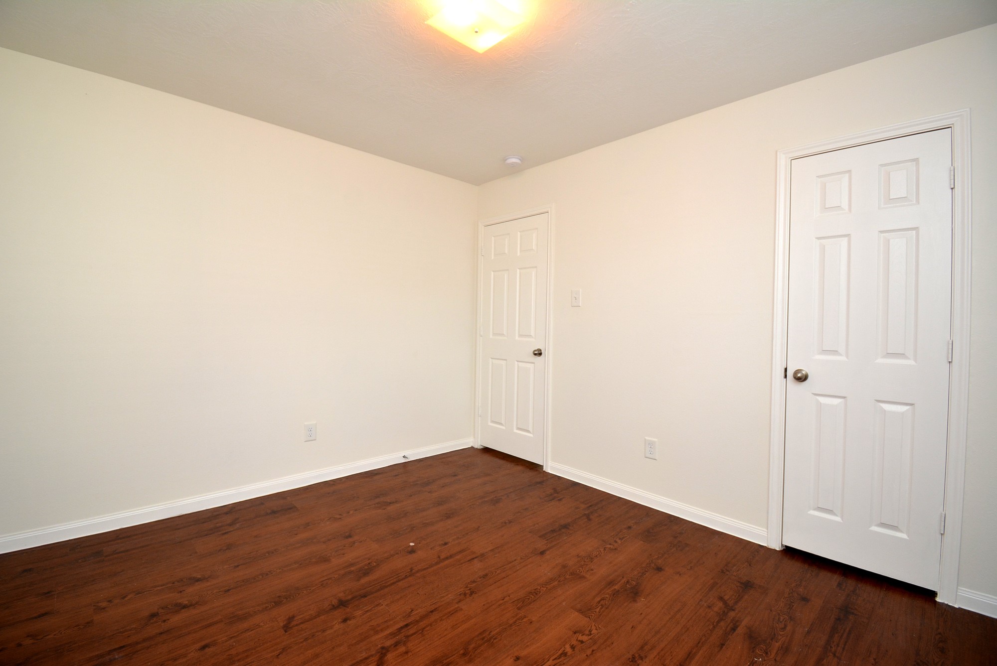 12010 Gregory Crossing Way Houston, TX 77067 - Photo 18 of 26 a view of an empty room with wooden floor