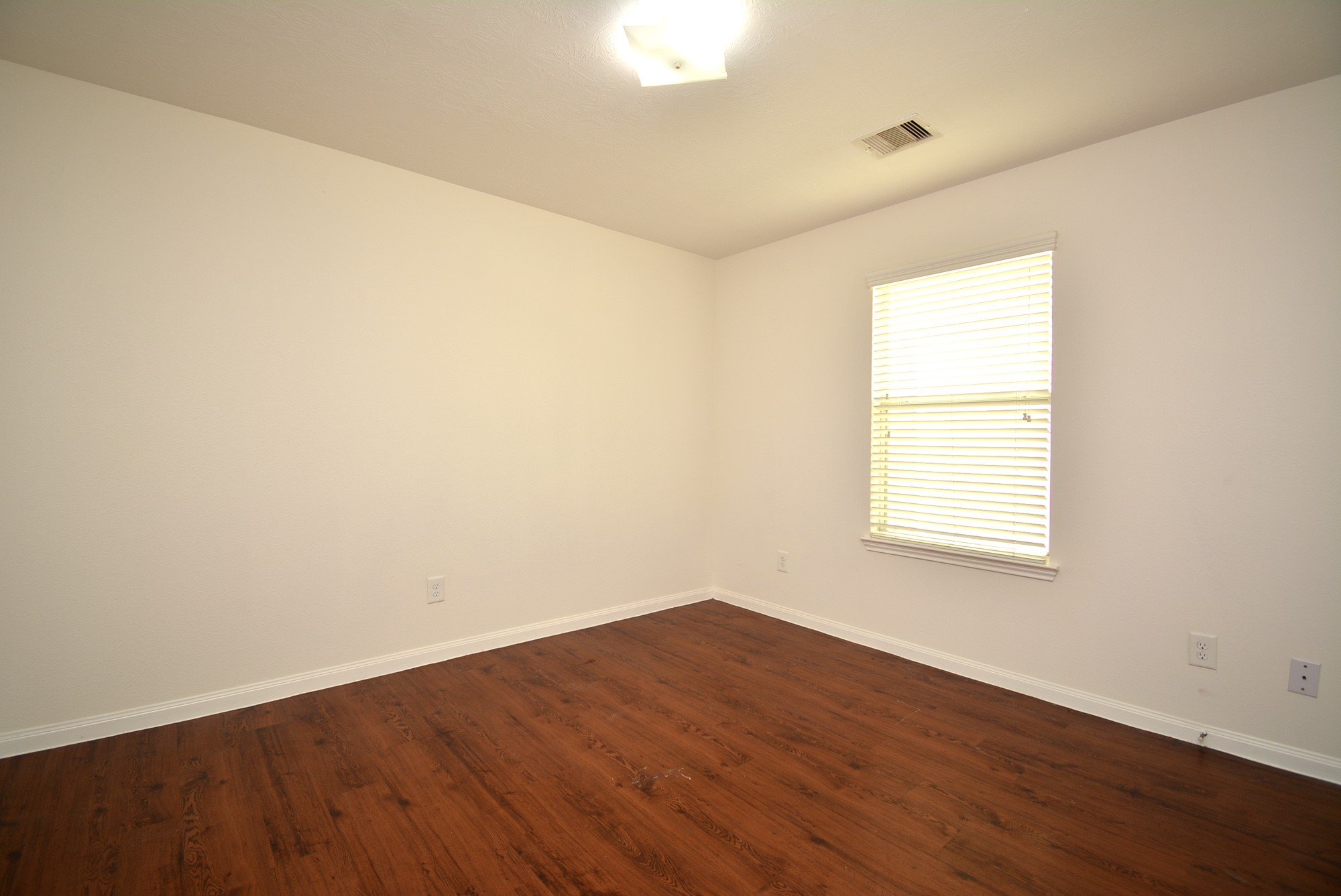 12010 Gregory Crossing Way Houston, TX 77067 - Photo 21 of 26 an empty room with wooden floor and windows