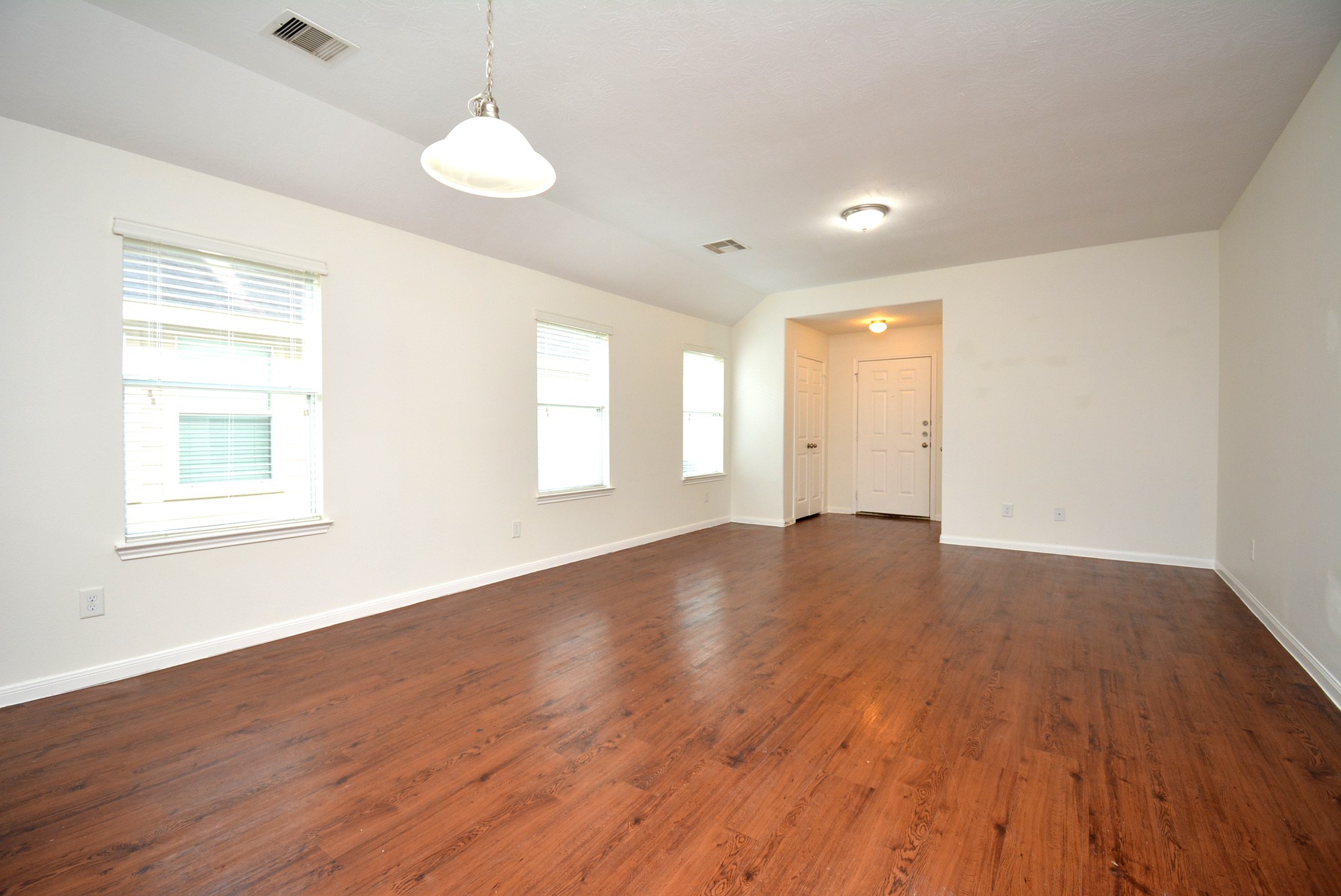 12010 Gregory Crossing Way Houston, TX 77067 - Photo 6 of 26 a view of an empty room with wooden floor and a window