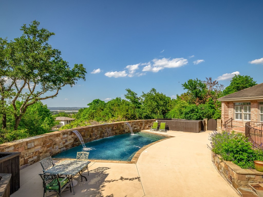 Welcome to 16015 Fontaine Ave.  Entering through the pool deck you are greeted with views of Lake Travis.