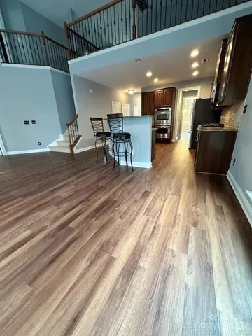 a view of a room with wooden floor