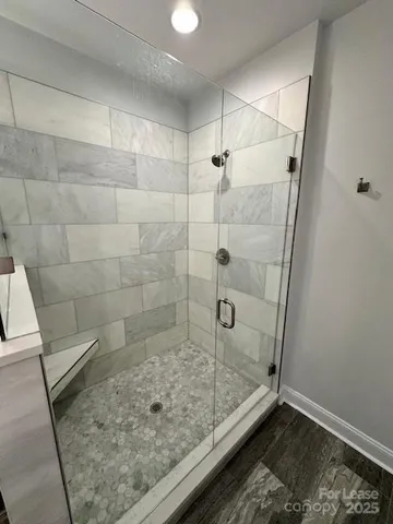 an empty room with windows and ceiling fan