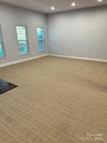 a view of kitchen with stainless steel appliances granite countertop a sink and a microwave