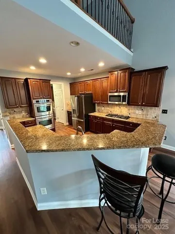 a living room with a couch and wooden floor