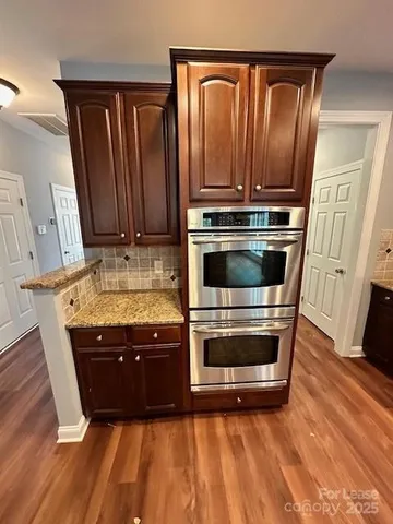 a view of room with wooden floor
