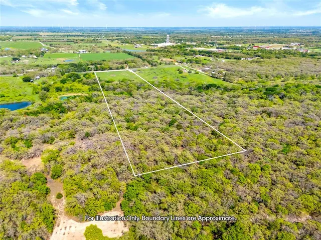 a view of a field with an ocean