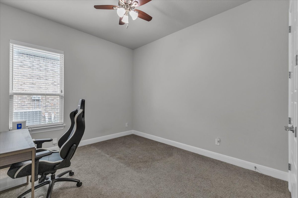 21301 Resource Road Pflugerville, TX 78660 - Photo 18 of 29 Neutral wall color with a window featuring blinds. Extra bedroom can use as an office or play room.
