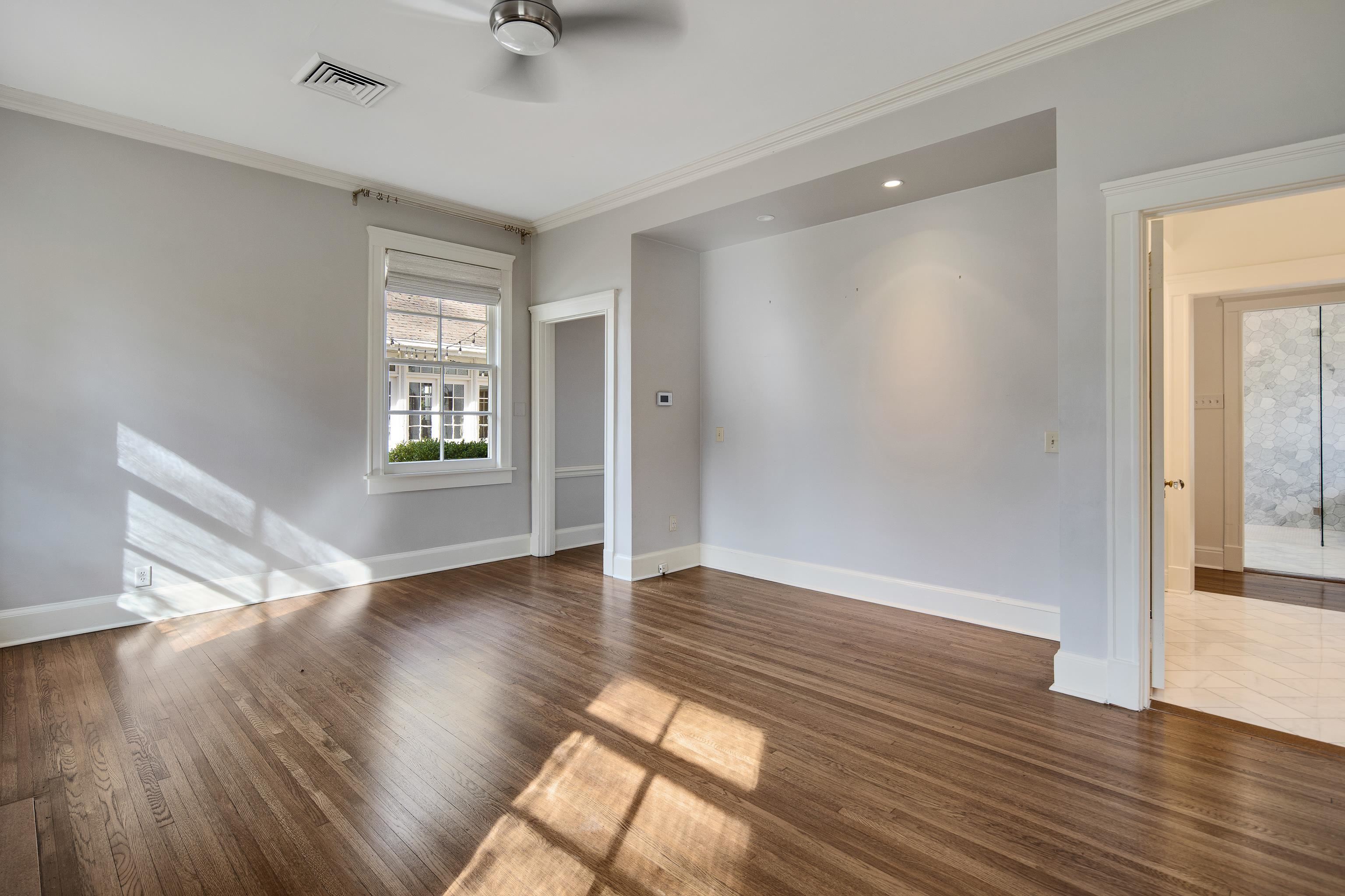 505 Goodwyn Street Memphis, TN 38111 - Photo 18 of 40 an empty room with wooden floor and windows