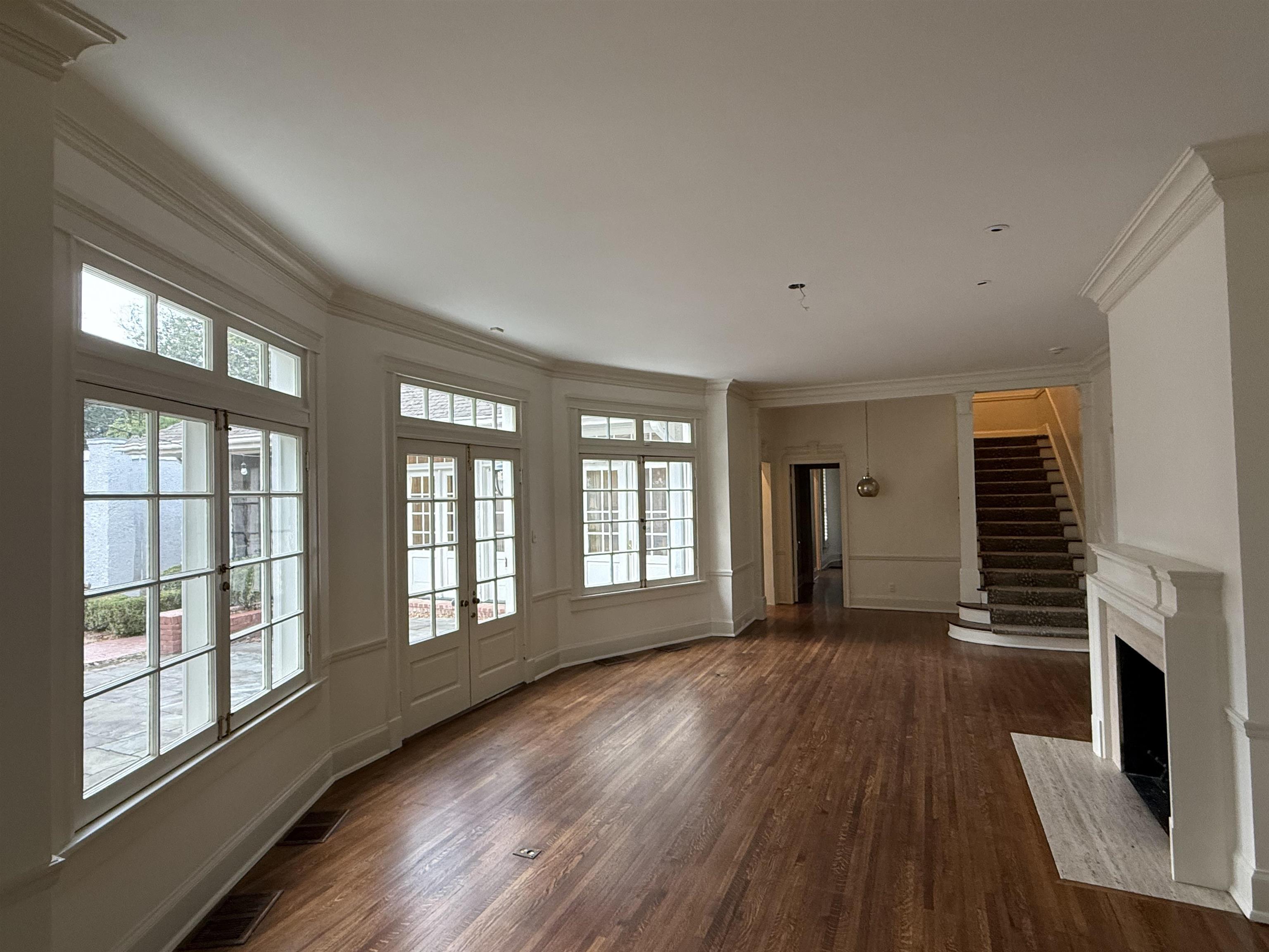 505 Goodwyn Street Memphis, TN 38111 - Photo 25 of 40 a view of an empty room with wooden floor and a window