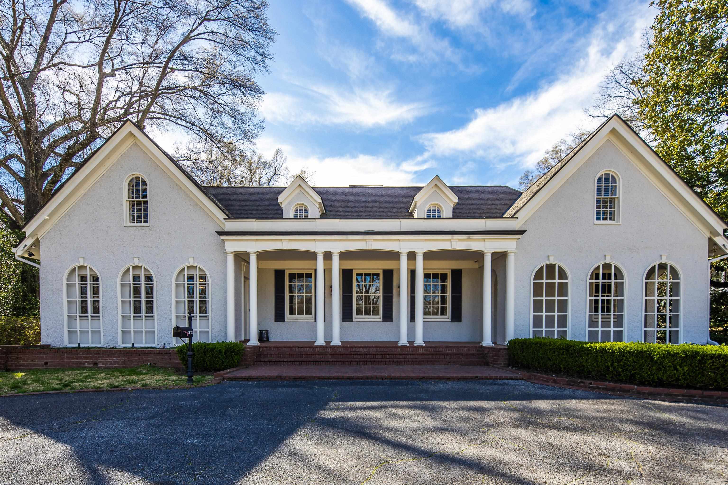 505 Goodwyn Street Memphis, TN 38111 - Photo 3 of 40 a view of a white house with large windows and a tree