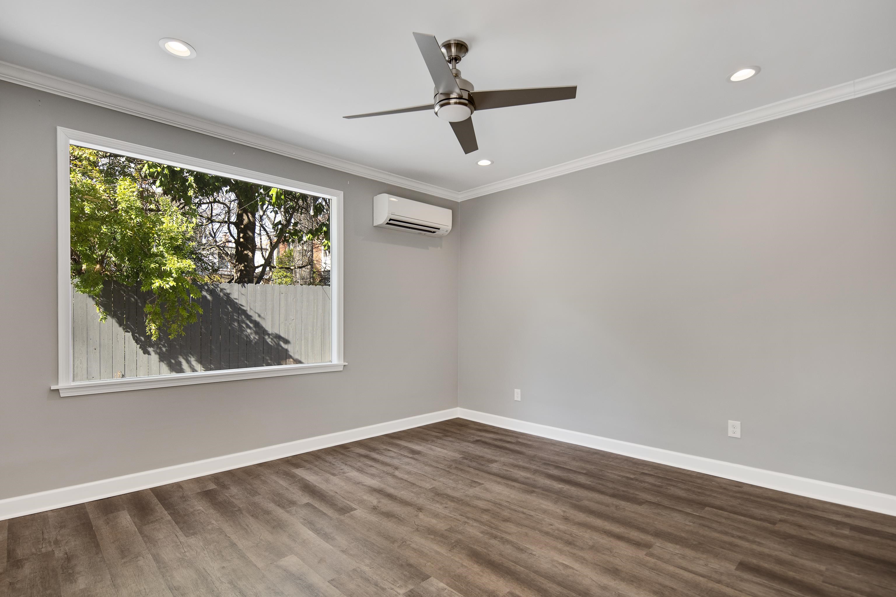 505 Goodwyn Street Memphis, TN 38111 - Photo 37 of 40 a view of a livingroom with wooden floor and a ceiling fan