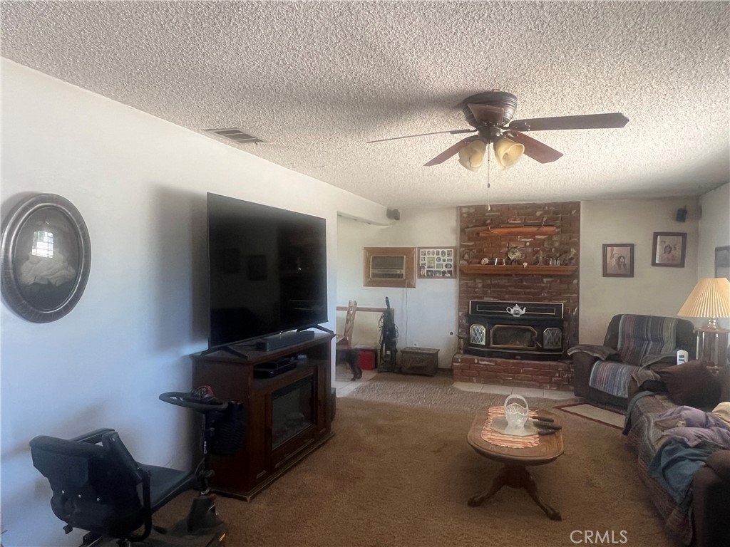 15411 Ash Street Hesperia, CA 92345 - Photo 8 of 11 a living room with furniture and a flat screen tv