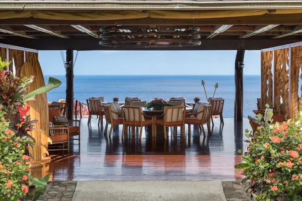 a view of a patio with dining table and chairs with potted plants