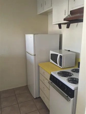 a kitchen with a stove and a refrigerator