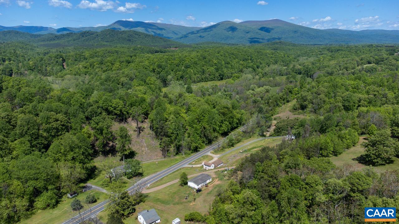1890 River Road Faber, VA 22938 - Photo 13 of 17 a view of a lush green hillside and a building in the background
