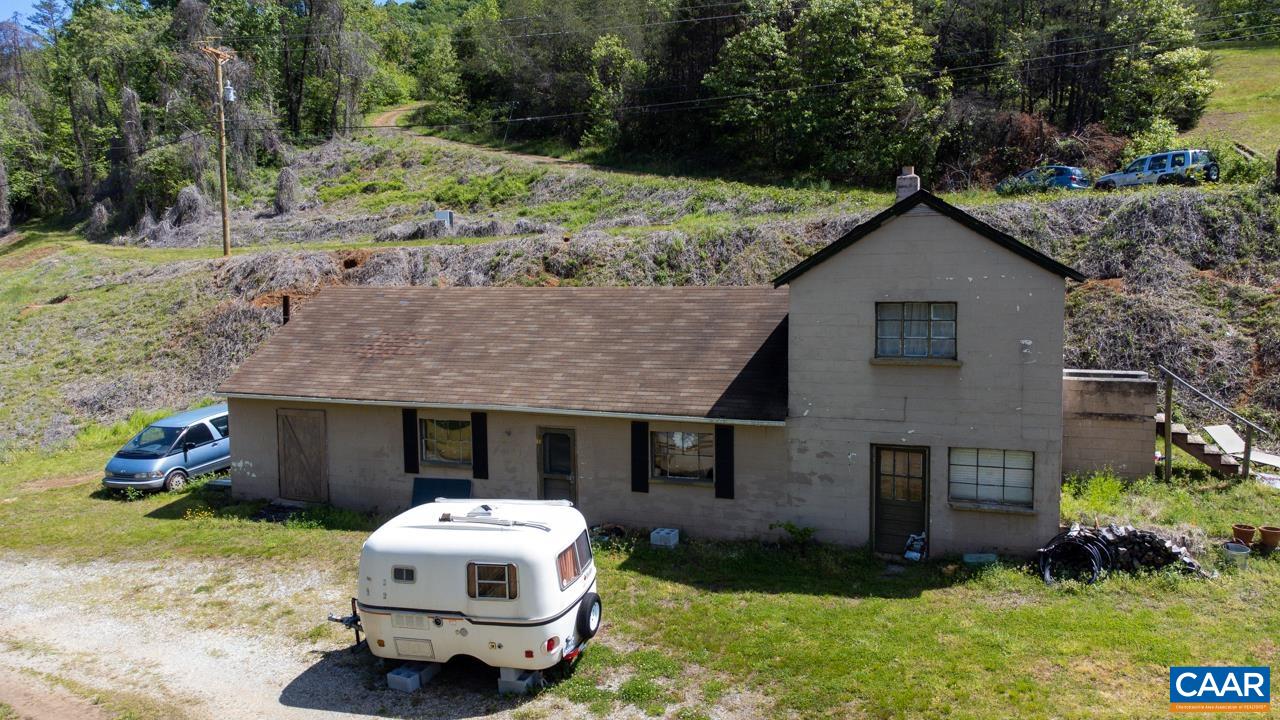 1890 River Road Faber, VA 22938 - Photo 15 of 17 a white house with a small yard and large trees