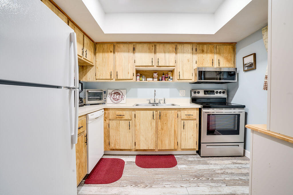 1900 South Kanner Highway, Unit 9206 Stuart, FL 34994 - Photo 2 of 23 a kitchen with stainless steel appliances granite countertop a refrigerator sink and stove