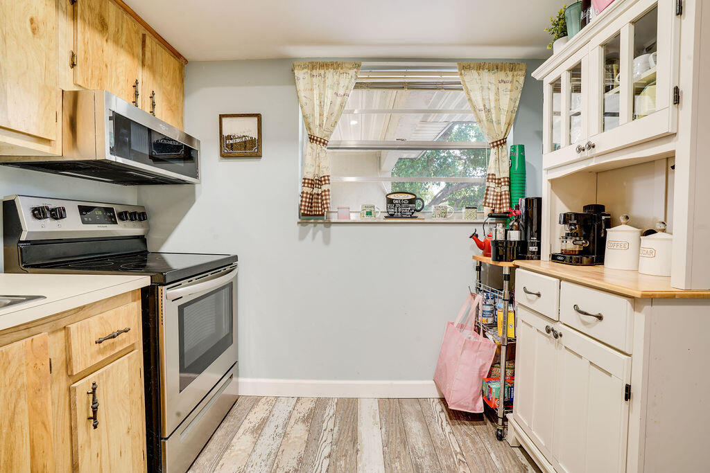 1900 South Kanner Highway, Unit 9206 Stuart, FL 34994 - Photo 3 of 23 a view of a kitchen with fridge and wooden floor