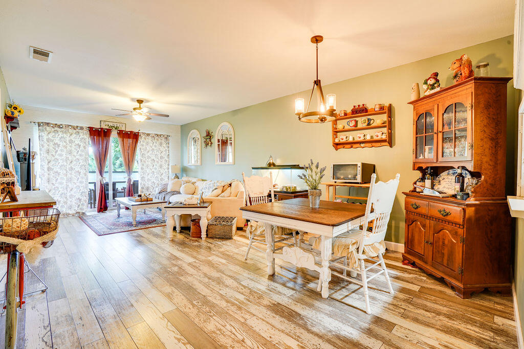 1900 South Kanner Highway, Unit 9206 Stuart, FL 34994 - Photo 5 of 23 a living room with furniture a dining table and chairs with wooden floor