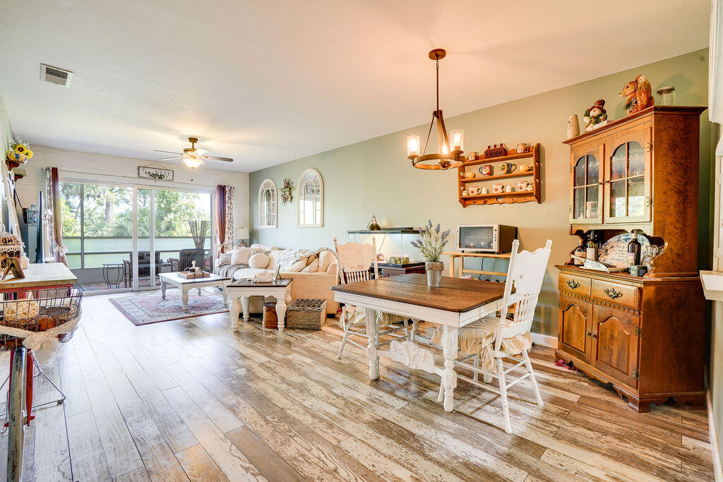 1900 South Kanner Highway, Unit 9206 Stuart, FL 34994 - Photo 6 of 23 a living room with furniture and a dining table with wooden floor