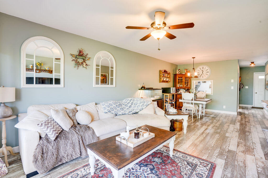1900 South Kanner Highway, Unit 9206 Stuart, FL 34994 - Photo 9 of 23 a living room with couches a dining table and kitchen view with wooden floor