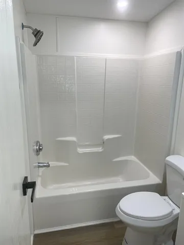 a bathroom with a toilet and a bathtub