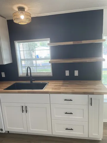 a kitchen with cabinets and window
